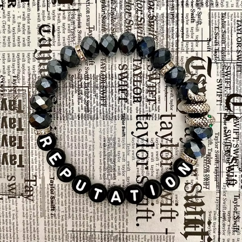 Black beaded bracelet with snake charm.
