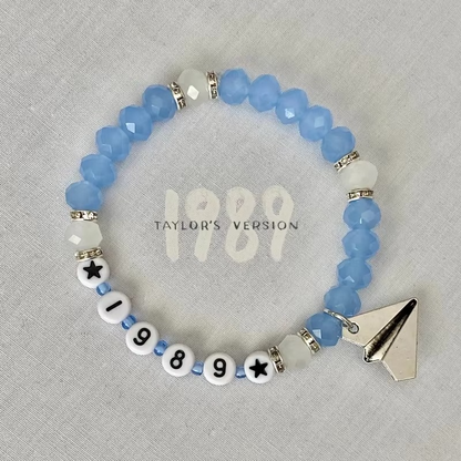 Beaded bracelet with '1989' and paper airplane charm