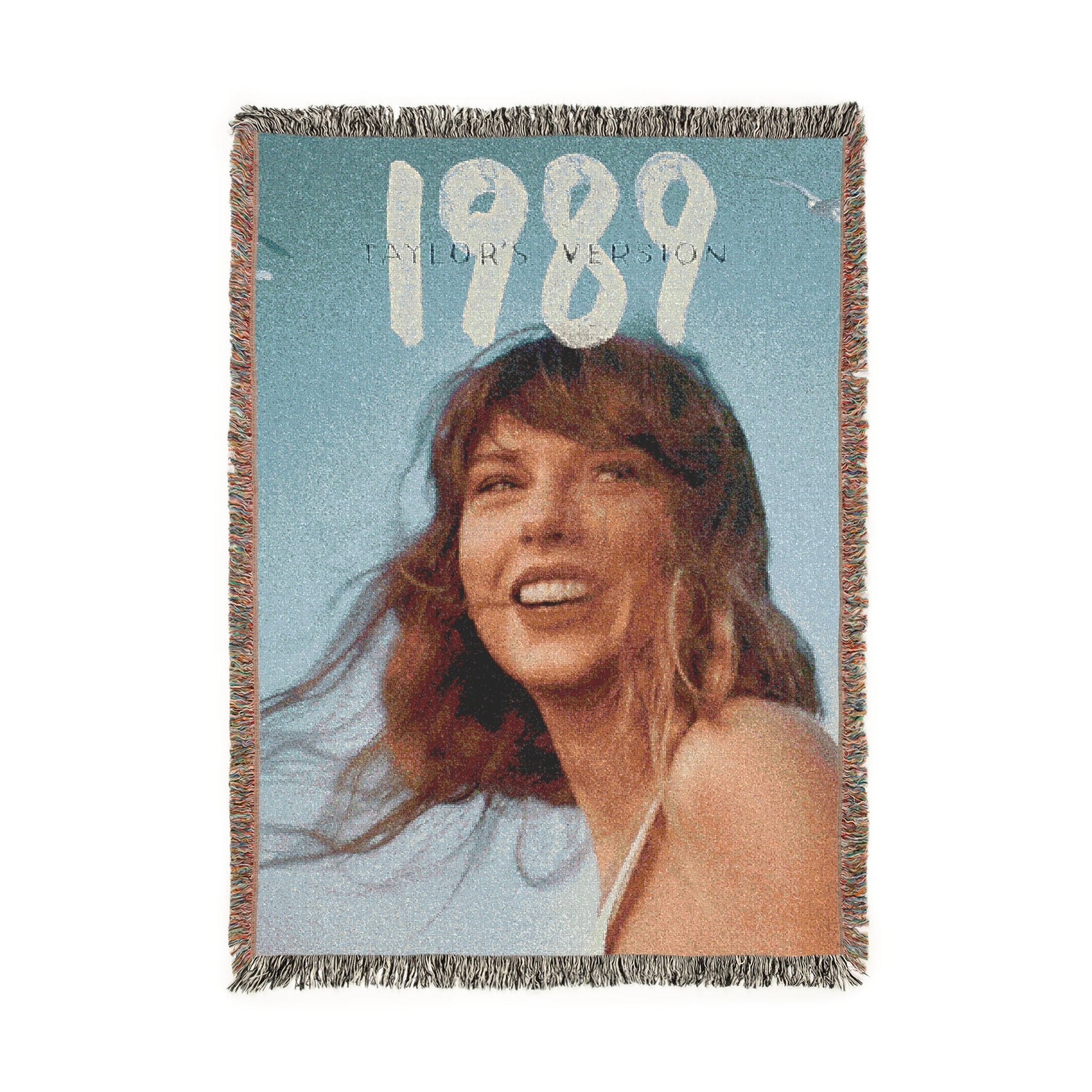 Woven blanket with a taylor swift's face and '1989' text on a blue background