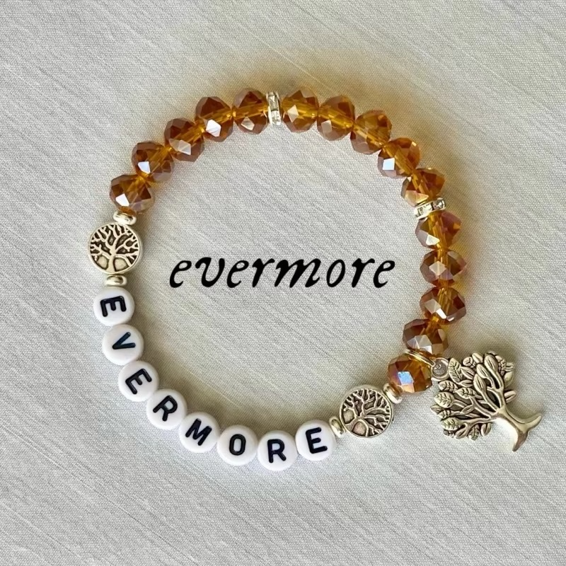 Bracelet with amber beads and silver tree charms.