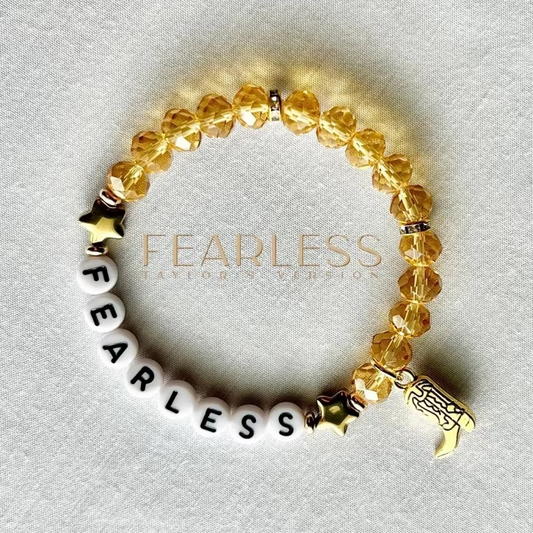 Bracelet with yellow beads, 'FEARLESS'  and boot charm.
