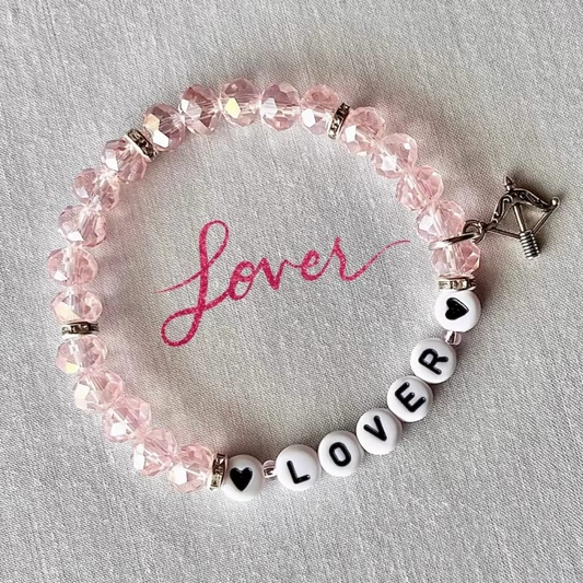 Beaded bracelet with 'LOVER' beads and archer silver charm.