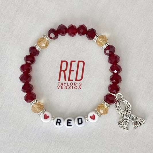 Bracelet with red beads and silver scarf charm