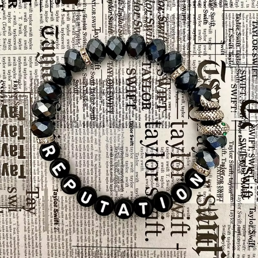 Black beaded bracelet with snake charm.