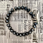 Black beaded bracelet with snake charm.