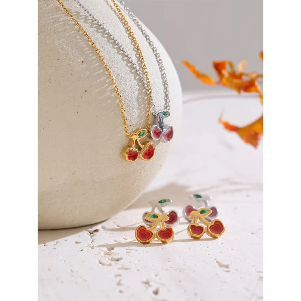 cherry necklace and earrings set with red enamel cherries and green leaf details