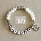 TTPD beaded bracelet with white and smoky crystal beads, heart accents, and a silver typewriter charm inspired by The Tortured Poets Department.