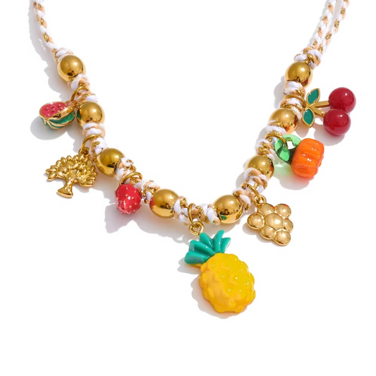 tropical fruit charm necklace with colorful enamel and glazed fruit pendants on a beaded chain.
