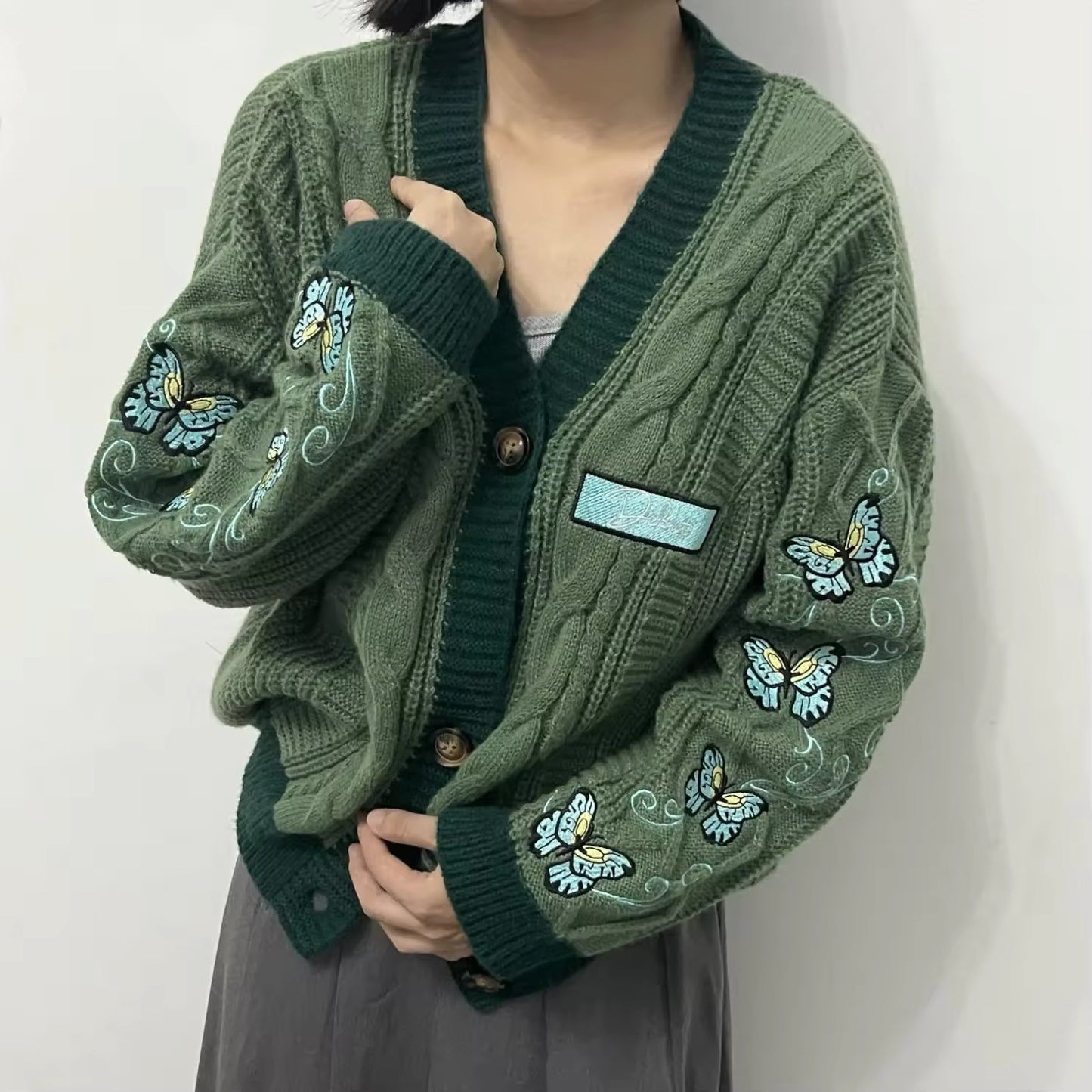 green taylor swift inspired cardigan with butterfly embroidery.